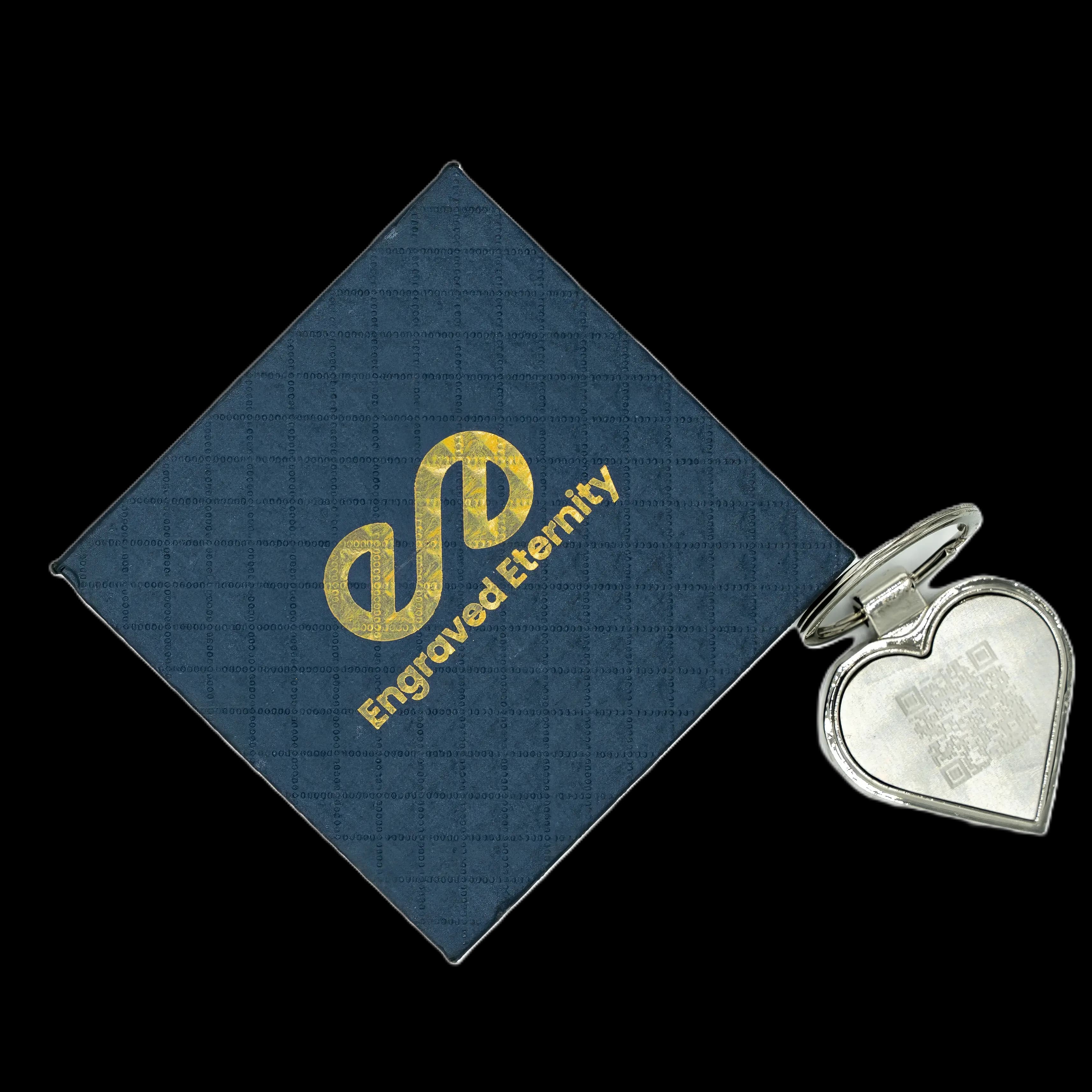 Navy blue box with Engraved Eternity branding in gold and a keyring with a QR code engraved